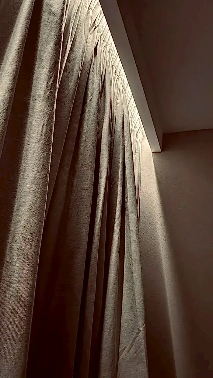 Cortina dramática con iluminación cálida en interior de Spa Belgrano